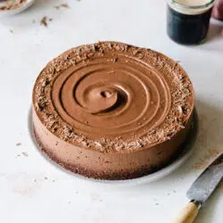 chocolate cheesecake with swirl detail next to a glass of guinness stout