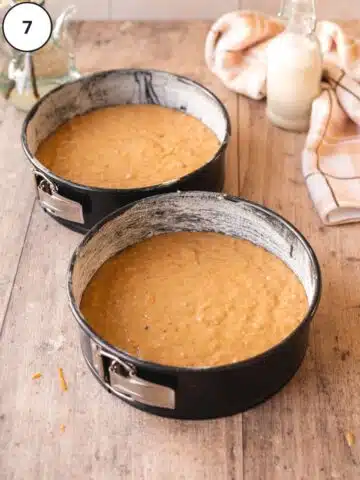 two lined 8 inch cake pans filled with vegan carrot cake batter.