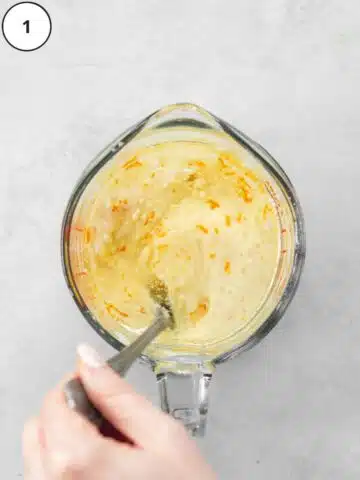 mixing wet ingredients for carrot cake in a jug.