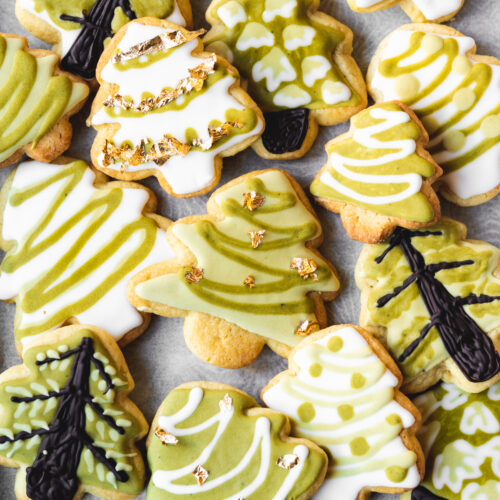 christmas tree cookies on a tray with parchment paper.