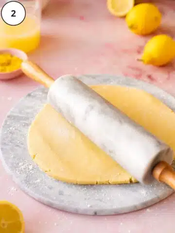 Rolling out the vegan tart dough using a marble rolling pin.