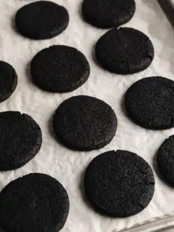 a parchment-lined cookie tray with baked oreo cookies.